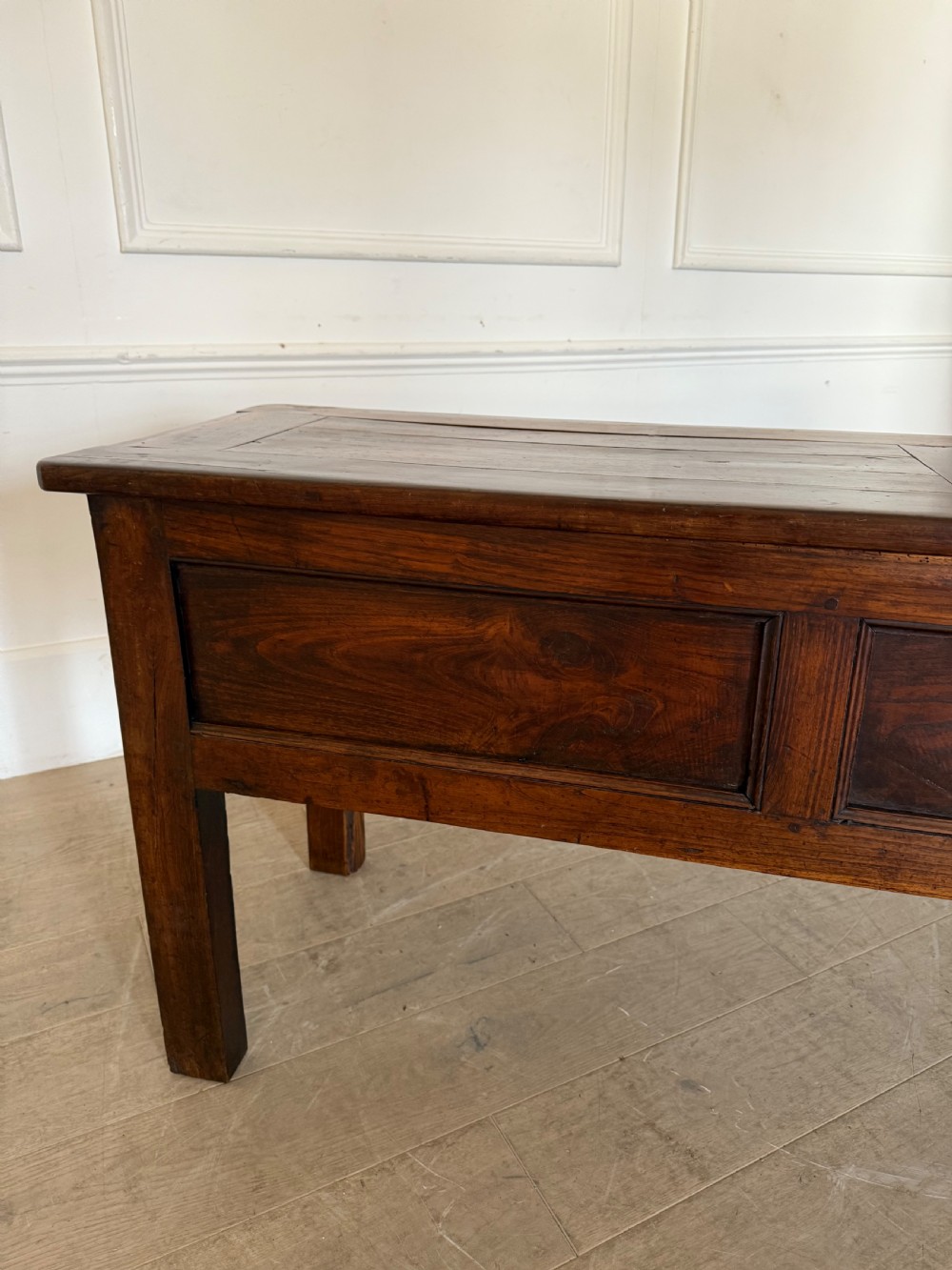 A rectangular early 19th-century chestnut dresser base featuring three drawers with turned wooden knobs and straight legs. View XIII