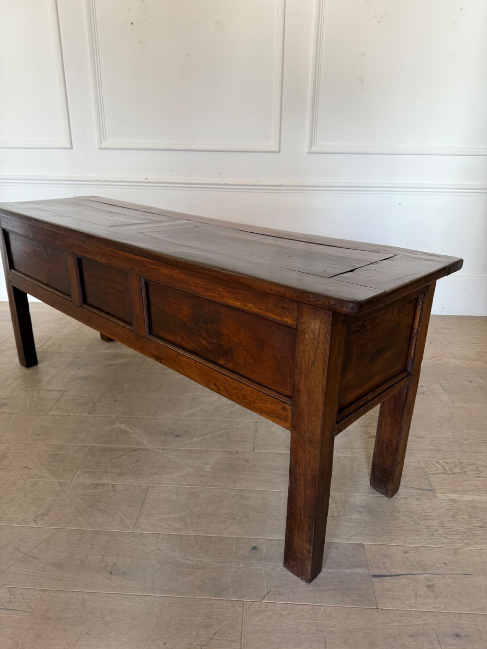 A rectangular early 19th-century chestnut dresser base featuring three drawers with turned wooden knobs and straight legs. View XIV