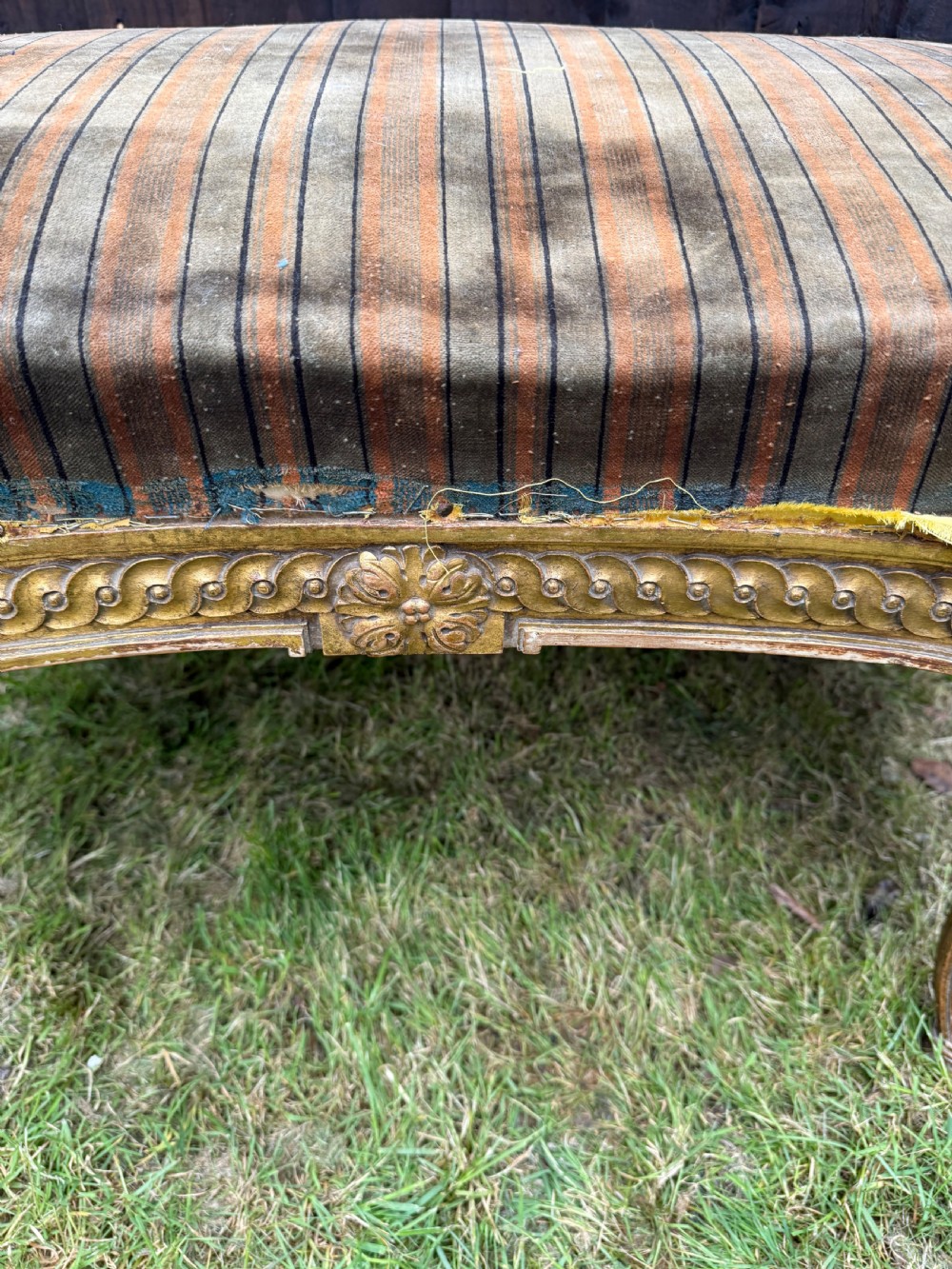 A Louis XVI style kidney-shaped stool featuring a carved giltwood frame with fluted legs and a striped fabric seat. View III