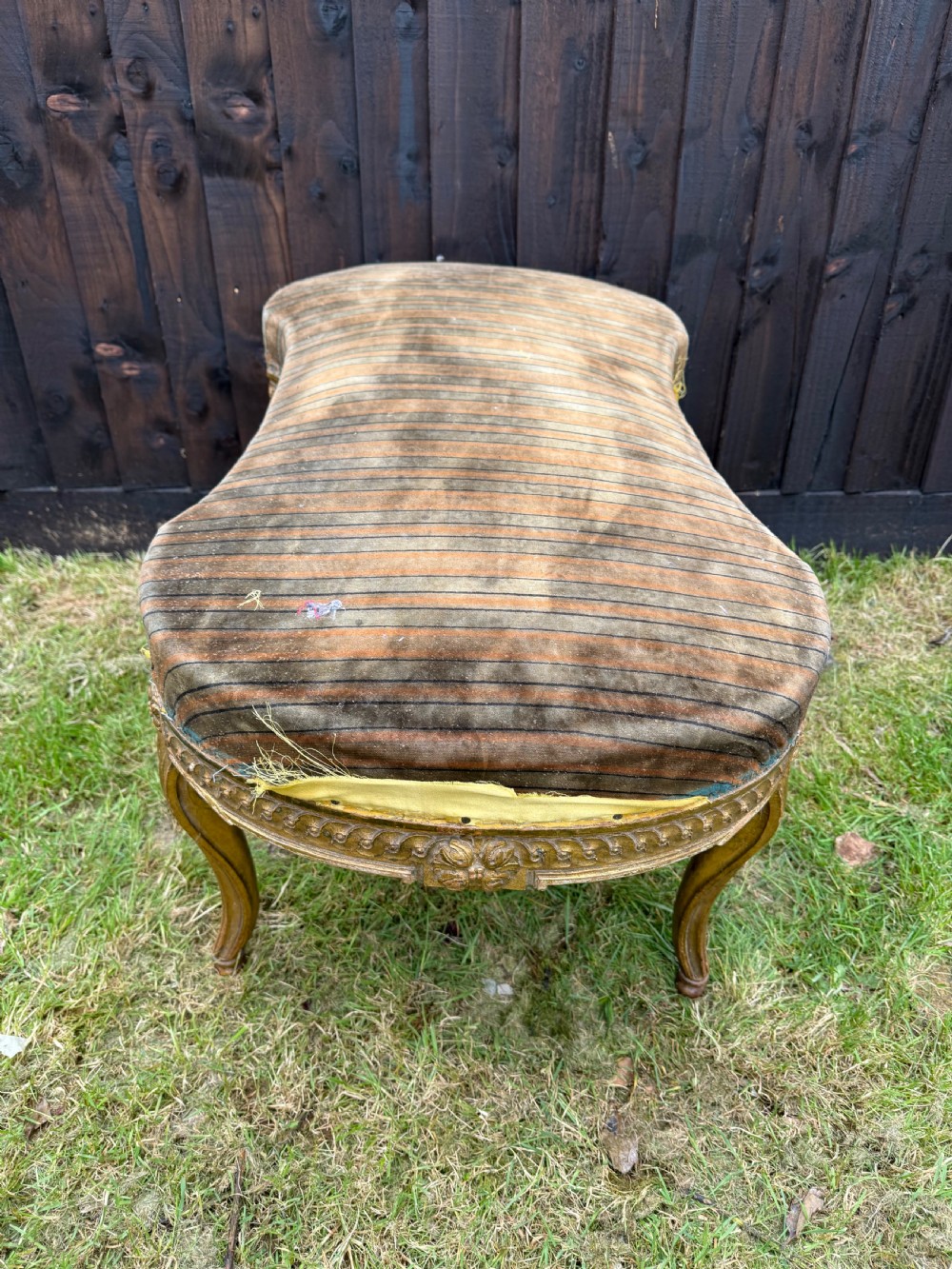A Louis XVI style kidney-shaped stool featuring a carved giltwood frame with fluted legs and a striped fabric seat. View VI