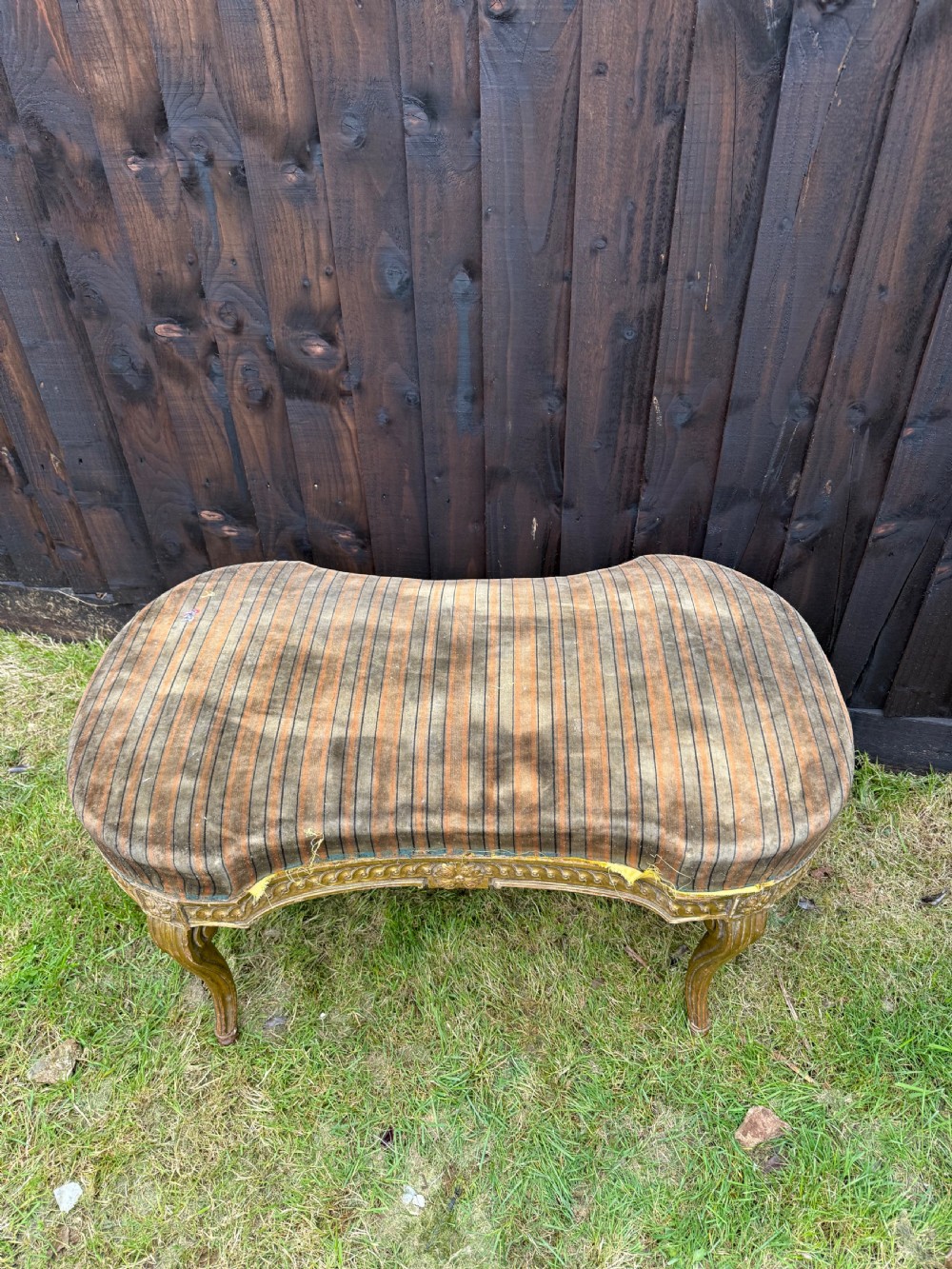 A Louis XVI style kidney-shaped stool featuring a carved giltwood frame with fluted legs and a striped fabric seat. View VII