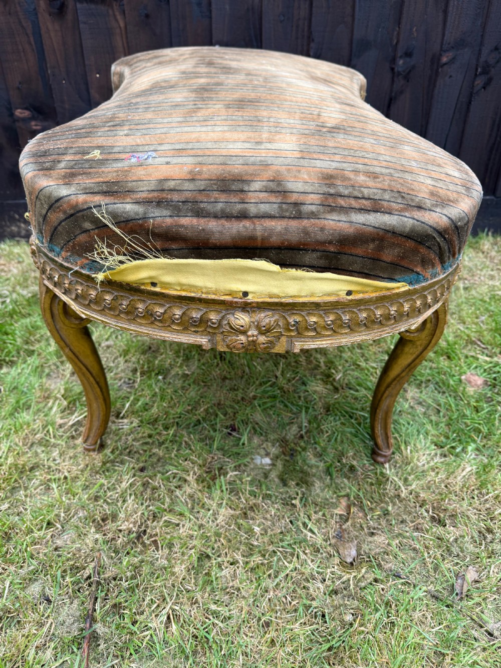 A Louis XVI style kidney-shaped stool featuring a carved giltwood frame with fluted legs and a striped fabric seat. View VIII