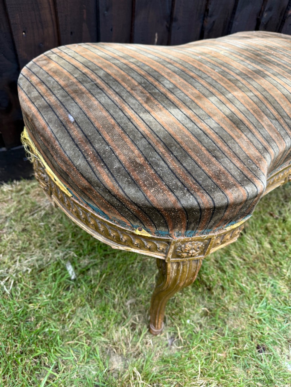 A Louis XVI style kidney-shaped stool featuring a carved giltwood frame with fluted legs and a striped fabric seat. View X
