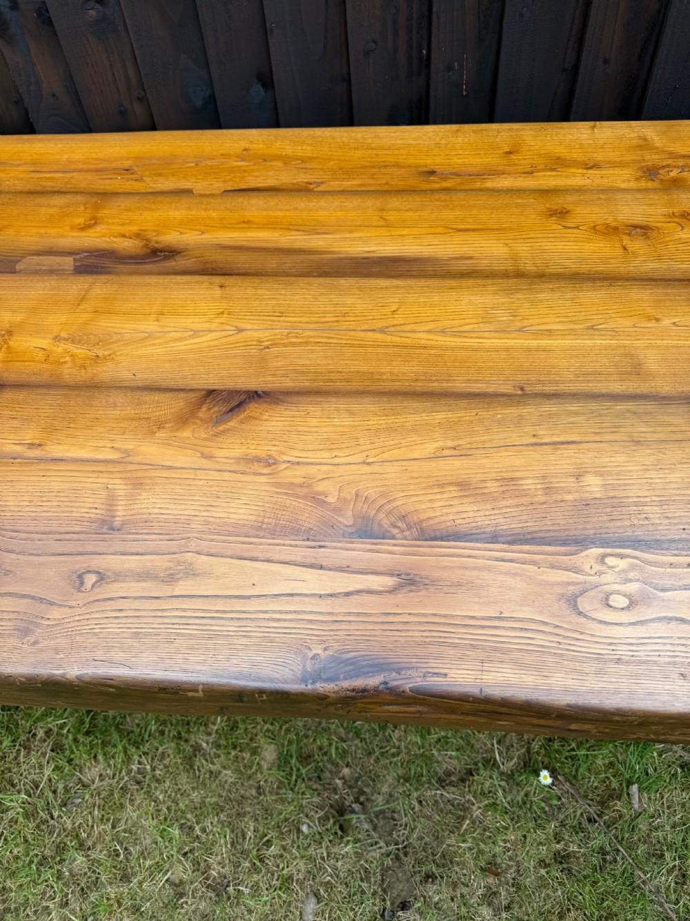 A large solid oak refectory dining table featuring a thick plank top, turned legs, and a low central stretcher base. View VI