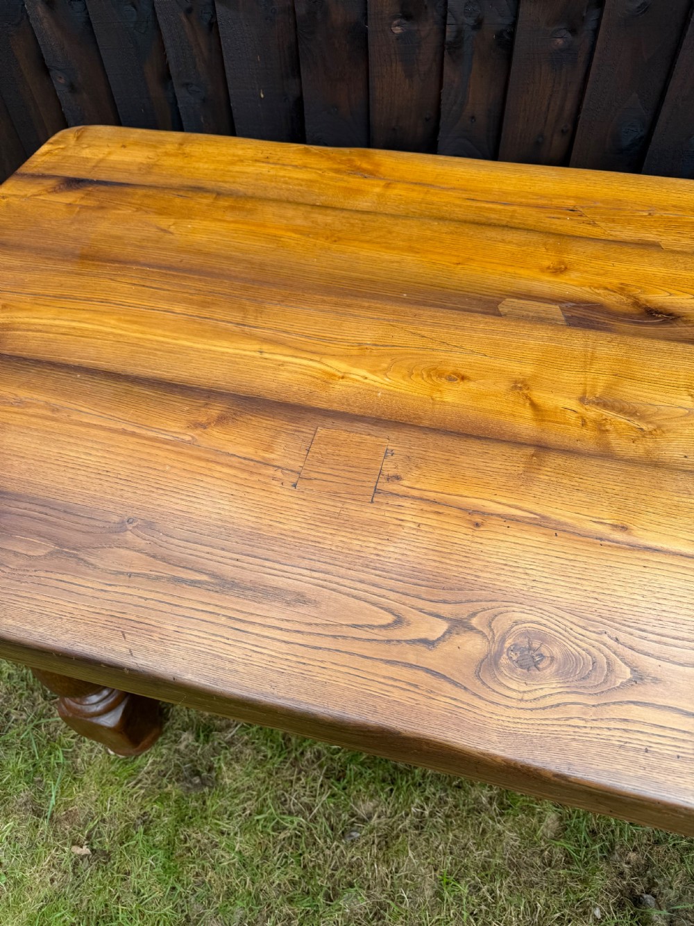 A large solid oak refectory dining table featuring a thick plank top, turned legs, and a low central stretcher base. View VIII