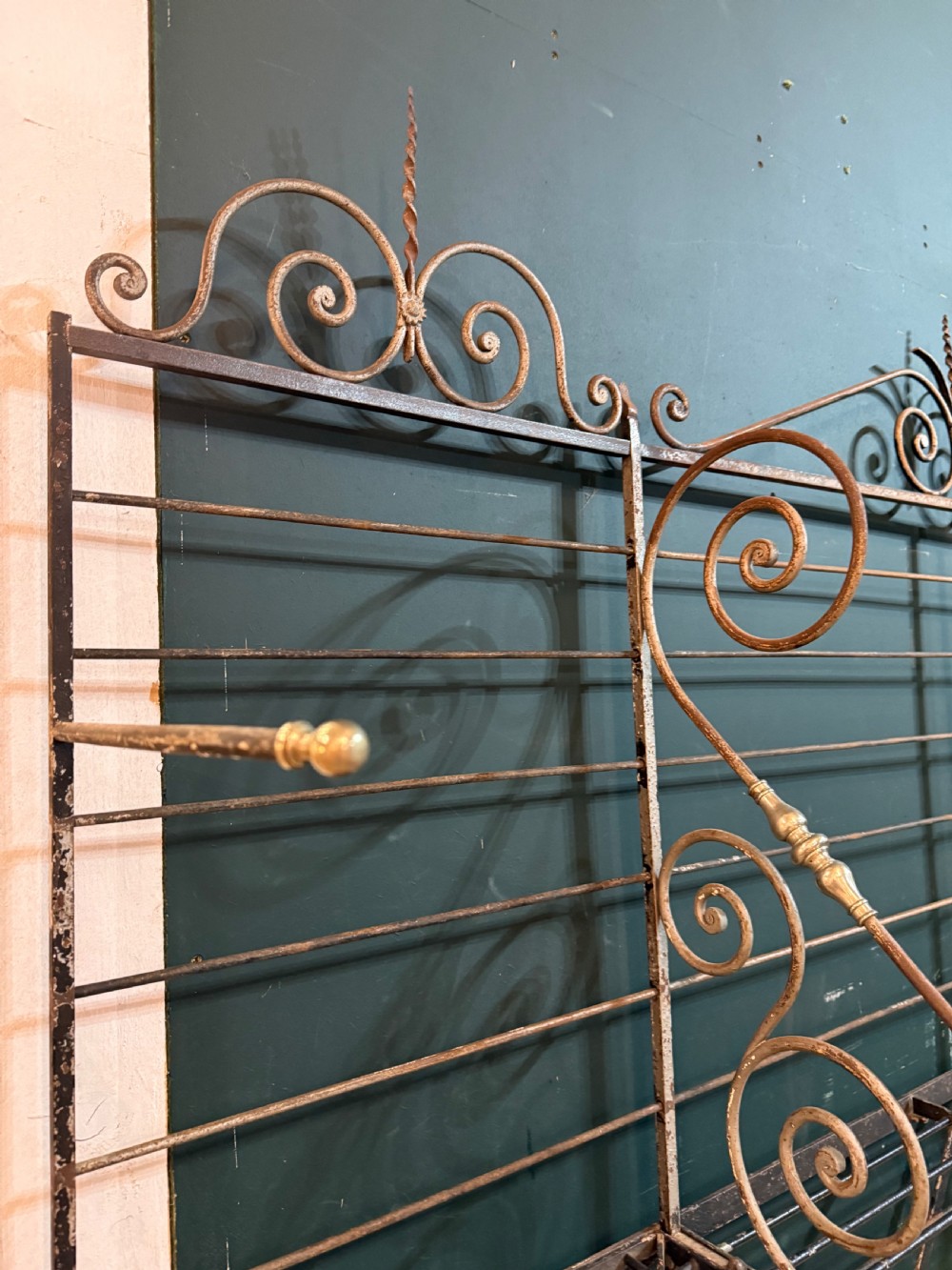 An antique French wrought iron and brass boulangerie rack featuring tier wire shelving and scrollwork cresting. View VIII