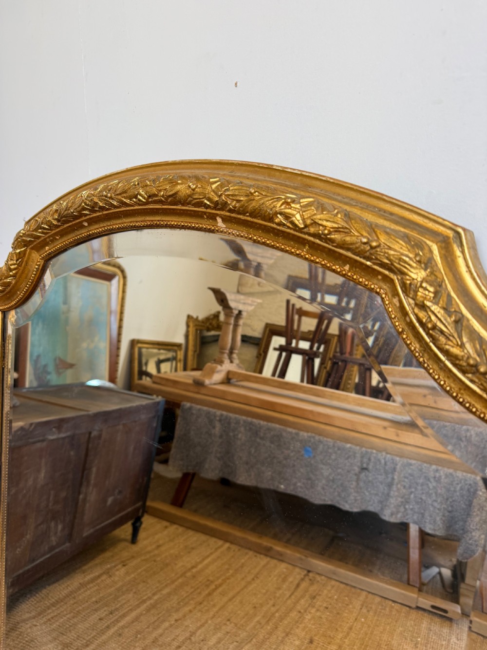 A late 19th-century tall arched-top wall mirror featuring a gilded wood frame with leaf moulding. View V