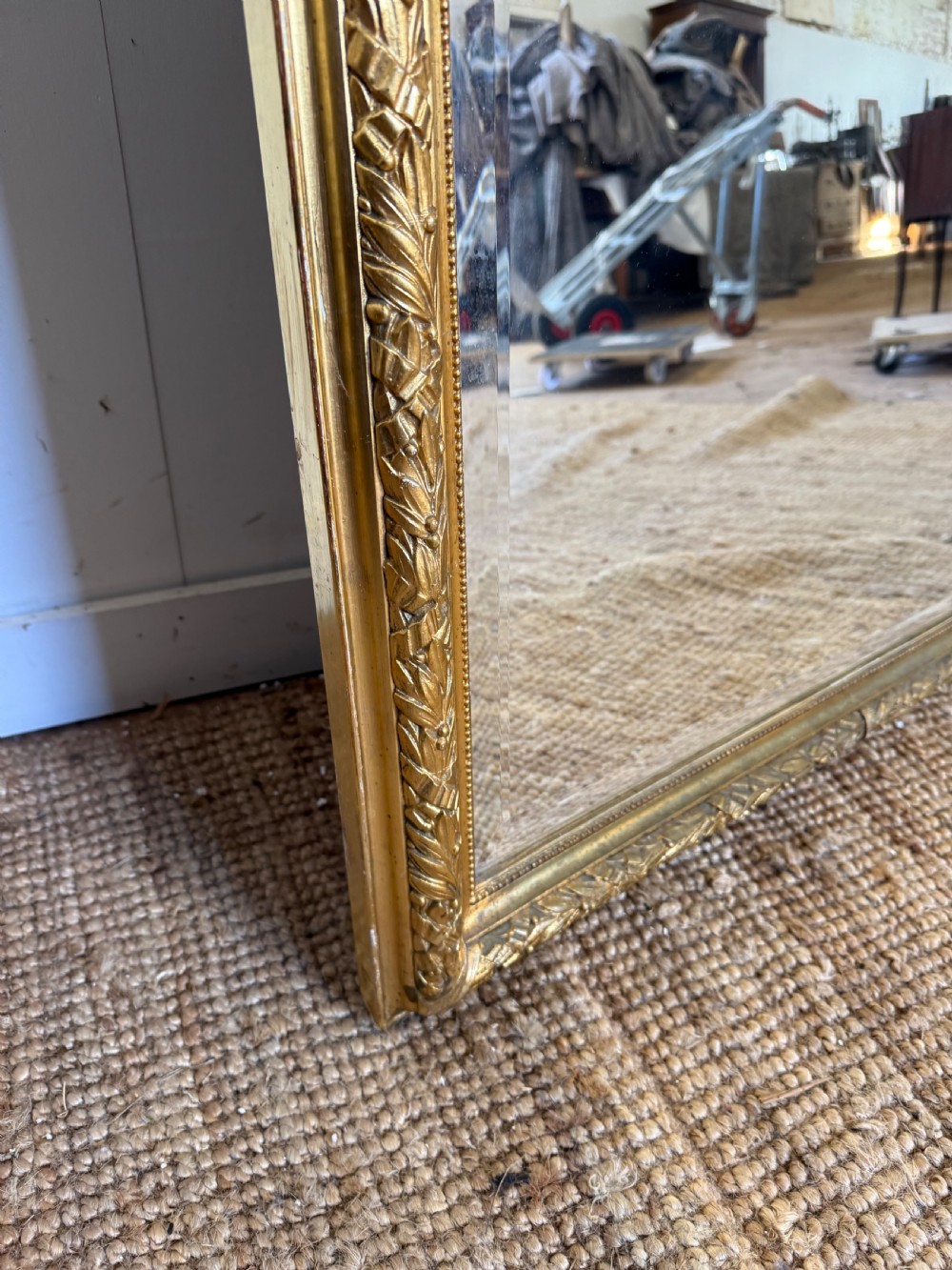 A late 19th-century tall arched-top wall mirror featuring a gilded wood frame with leaf moulding. View IX