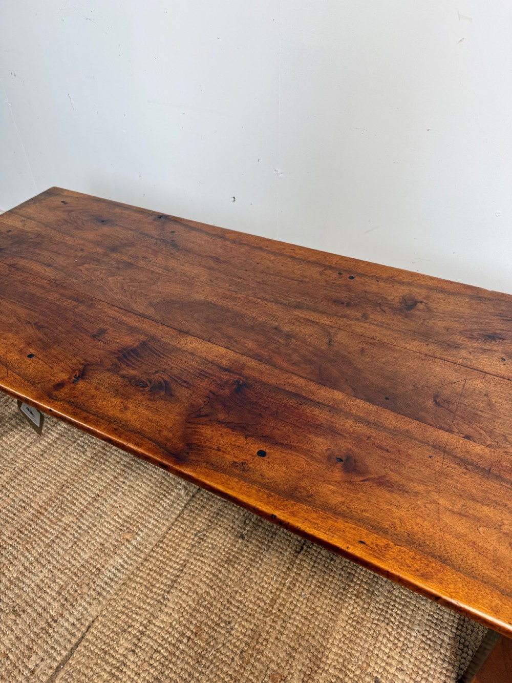 A large rectangular coffee table crafted from dark walnut wood featuring a plank top surface and four straight tapered legs. View III