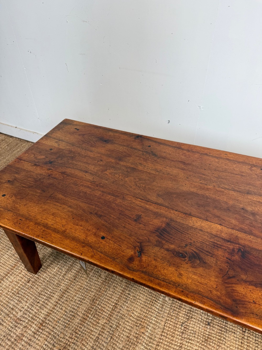 A large rectangular coffee table crafted from dark walnut wood featuring a plank top surface and four straight tapered legs. View V