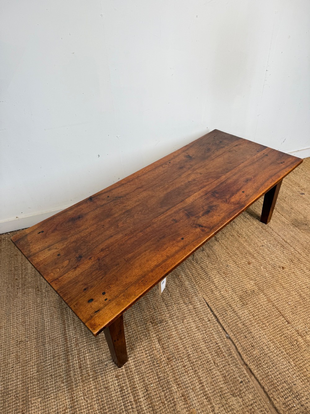 A large rectangular coffee table crafted from dark walnut wood featuring a plank top surface and four straight tapered legs. View VIII