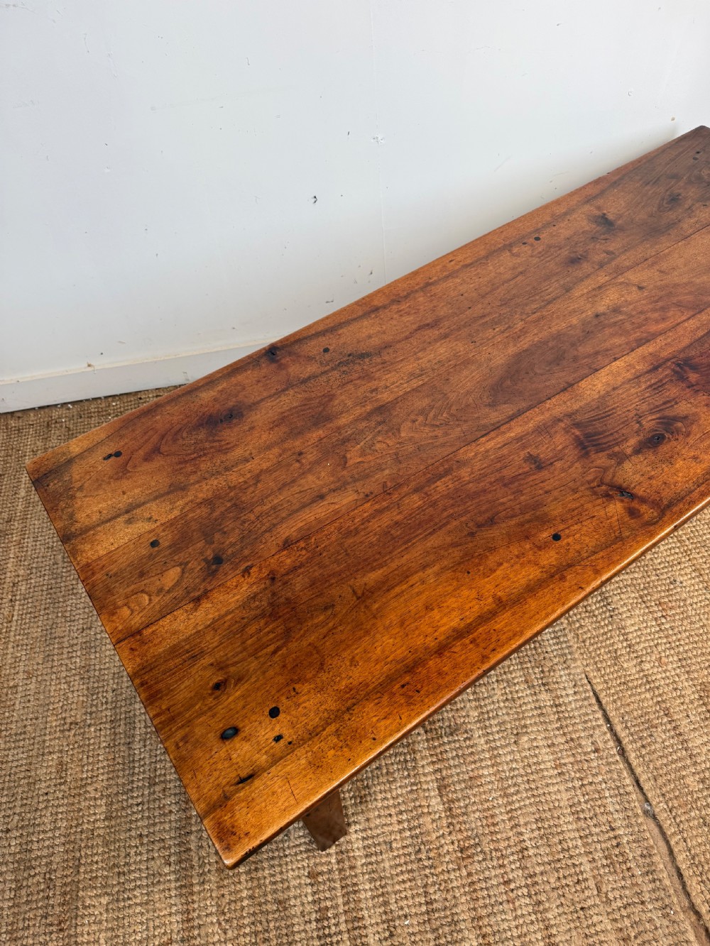 A large rectangular coffee table crafted from dark walnut wood featuring a plank top surface and four straight tapered legs. View XI
