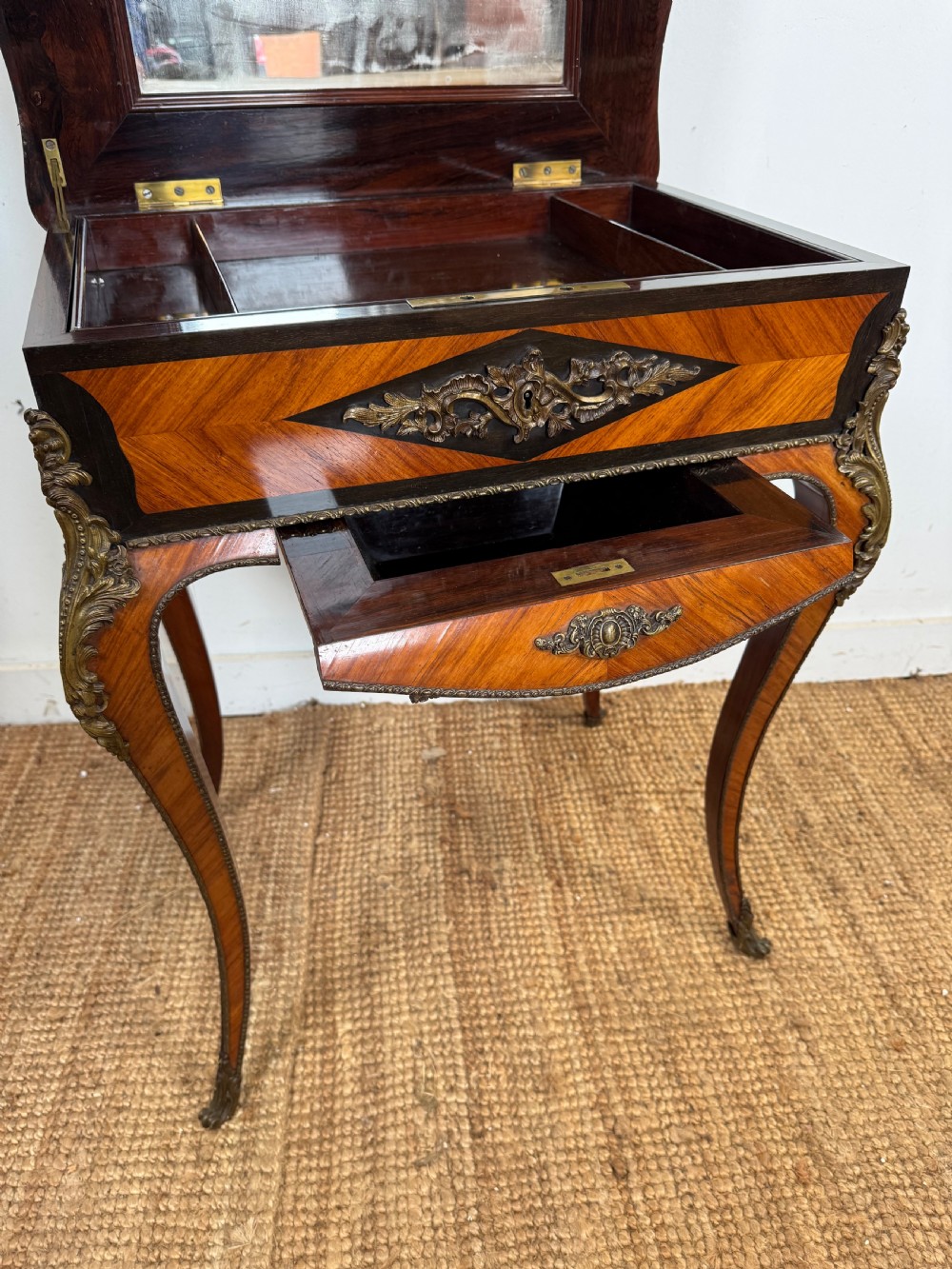 An antique French parquetry work table featuring a geometric optical illusion inlaid top, brass trim, and curved cabriole legs. View X