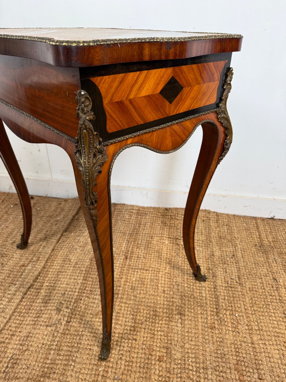 An antique French parquetry work table featuring a geometric optical illusion inlaid top, brass trim, and curved cabriole legs. View XI