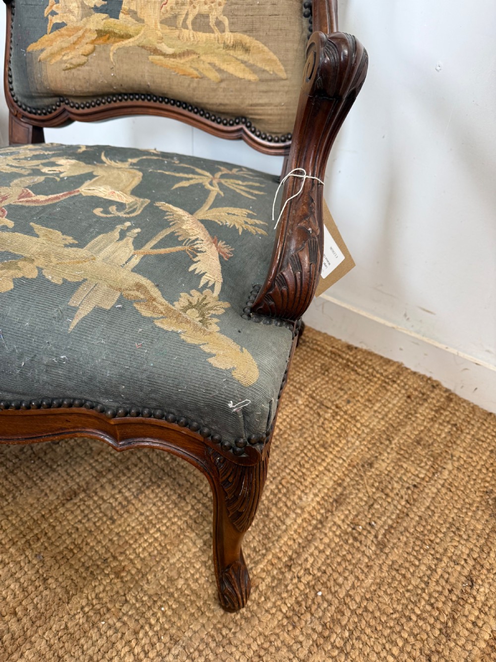 A late 19th-century open armchair with a carved walnut frame, cabriole legs, and muted green tapestry upholstery featuring pictorial motifs. View VII