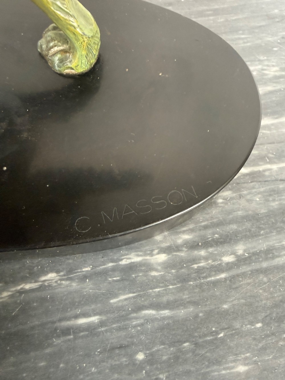 An Art Deco spelter sculpture depicting a prowling hunting dog with a green verdigris patina finish, mounted on an oval black marble base. View VI