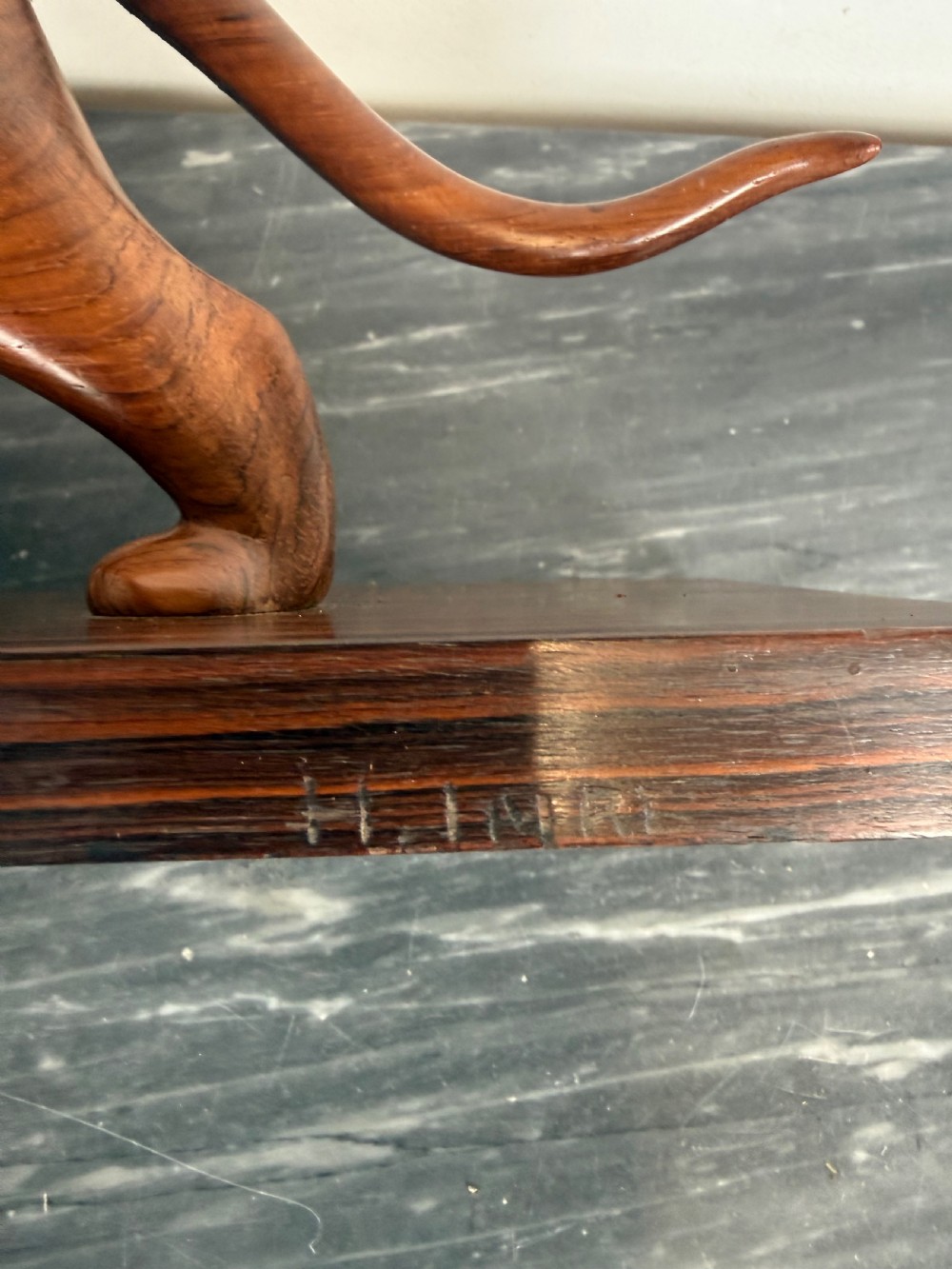 A carved dark wood Art Deco sculpture depicting a prowling panther mounted on a matching rectangular timber base. View VII