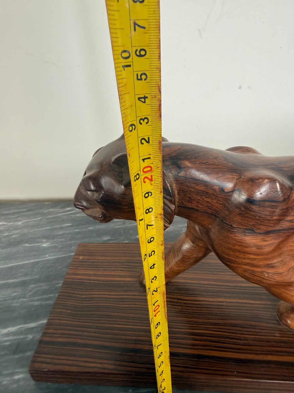 A carved dark wood Art Deco sculpture depicting a prowling panther mounted on a matching rectangular timber base. View XIV