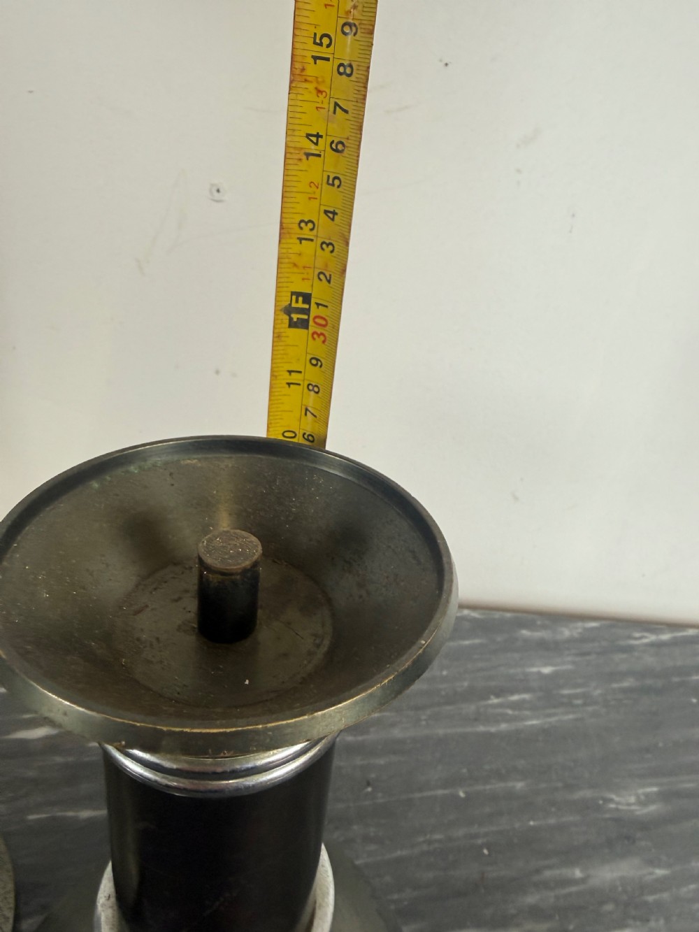 A pair of dark patinated metal Art Deco candlesticks featuring cylindrical columns, flared conical bases, and polished chrome ribbed bands. View VII