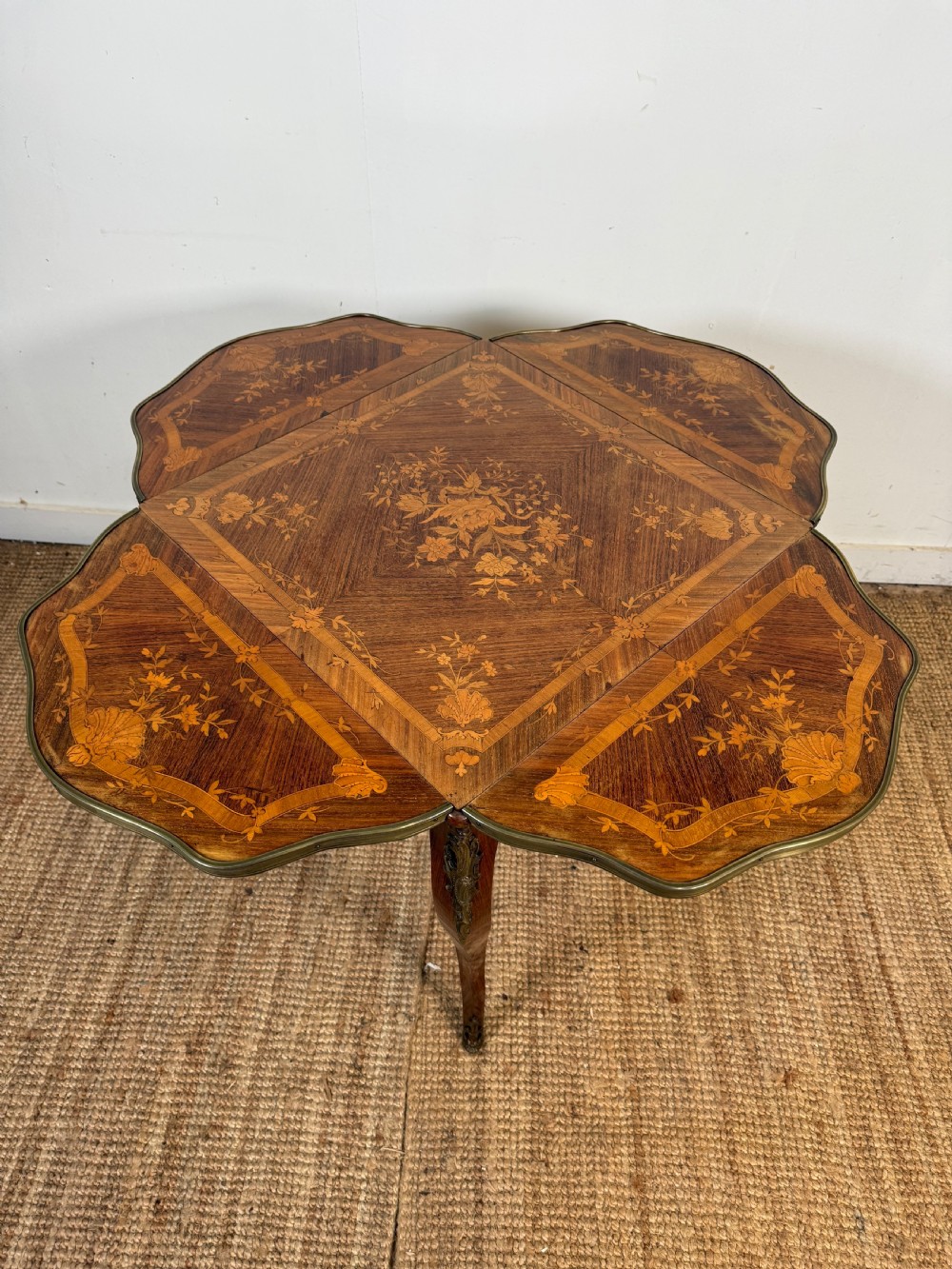 A French Napoleon III rosewood side table featuring floral marquetry inlays, drop leaves, and curved cabriole legs with brass mounts. View VI