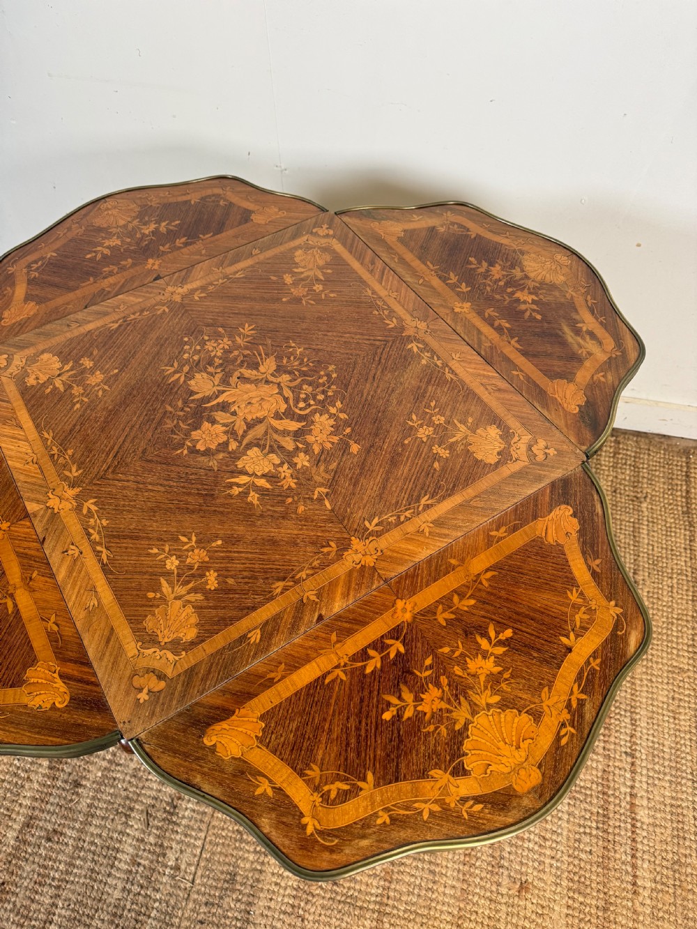 A French Napoleon III rosewood side table featuring floral marquetry inlays, drop leaves, and curved cabriole legs with brass mounts. View VII