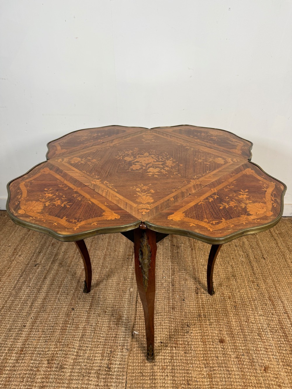 A French Napoleon III rosewood side table featuring floral marquetry inlays, drop leaves, and curved cabriole legs with brass mounts. View VIII