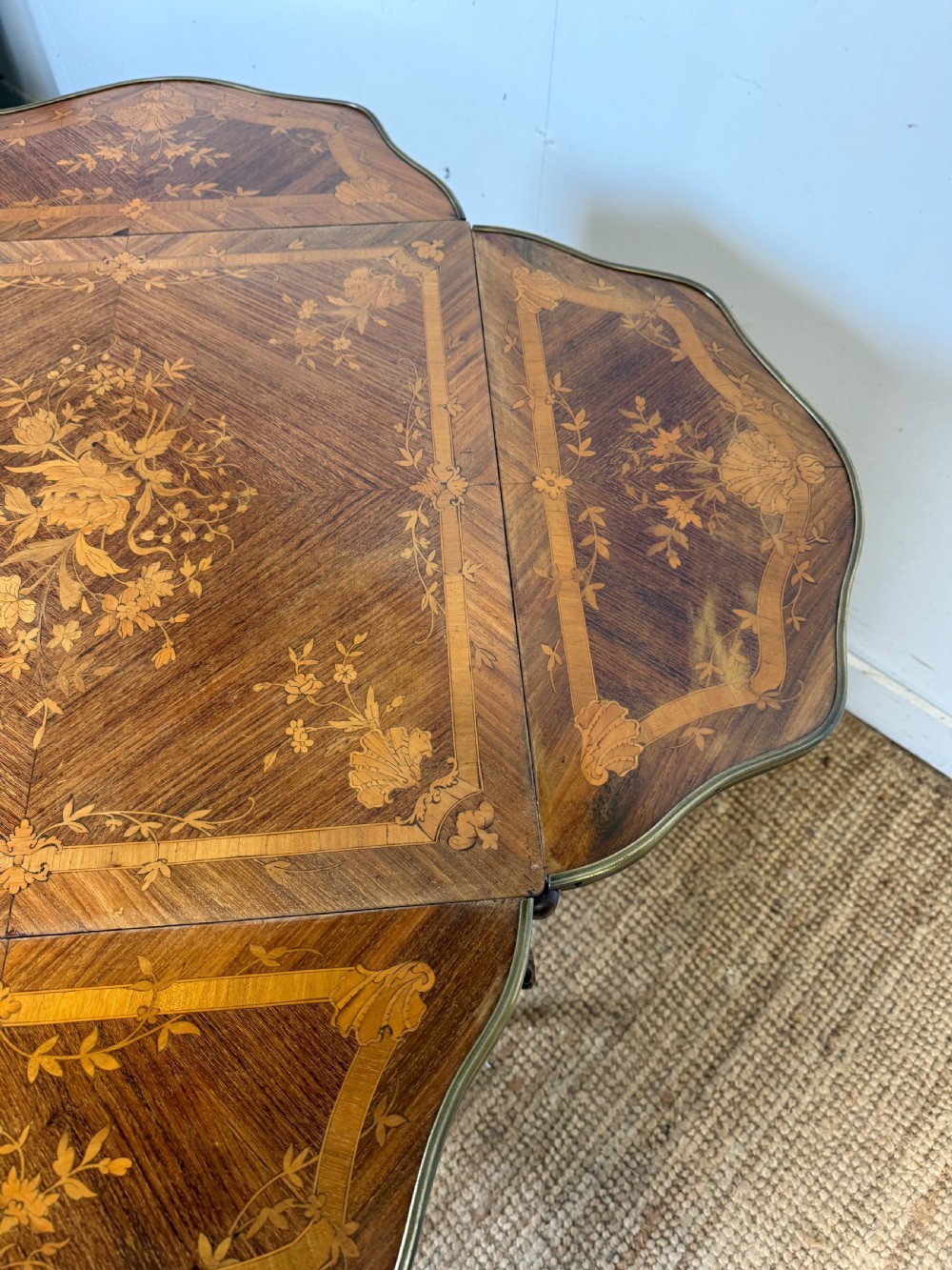A French Napoleon III rosewood side table featuring floral marquetry inlays, drop leaves, and curved cabriole legs with brass mounts. View IX