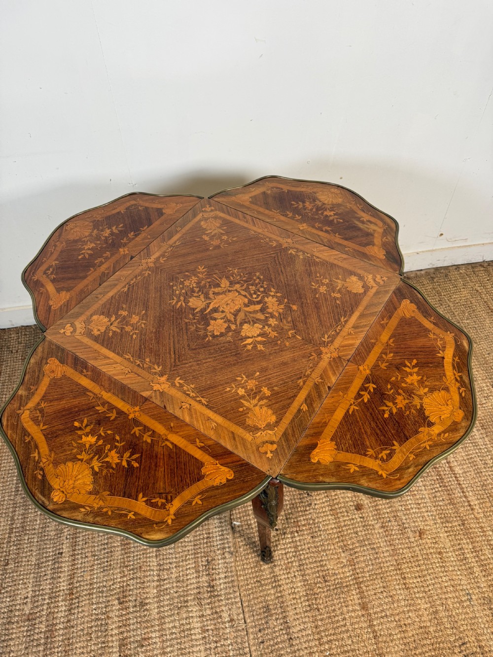 A French Napoleon III rosewood side table featuring floral marquetry inlays, drop leaves, and curved cabriole legs with brass mounts. View X