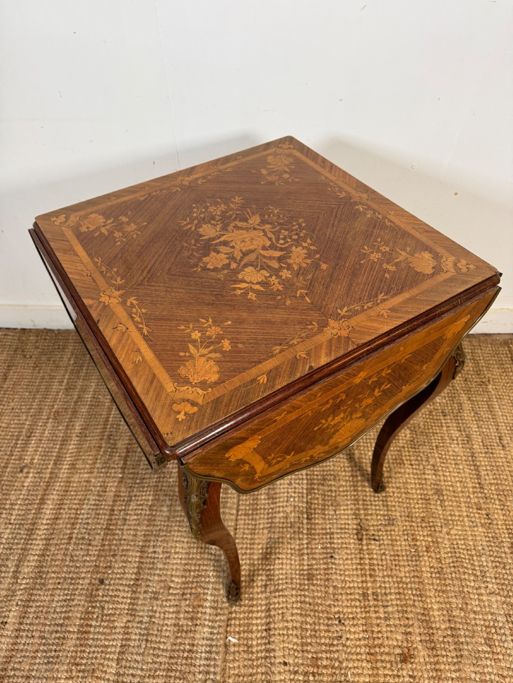 A French Napoleon III rosewood side table featuring floral marquetry inlays, drop leaves, and curved cabriole legs with brass mounts. View XII