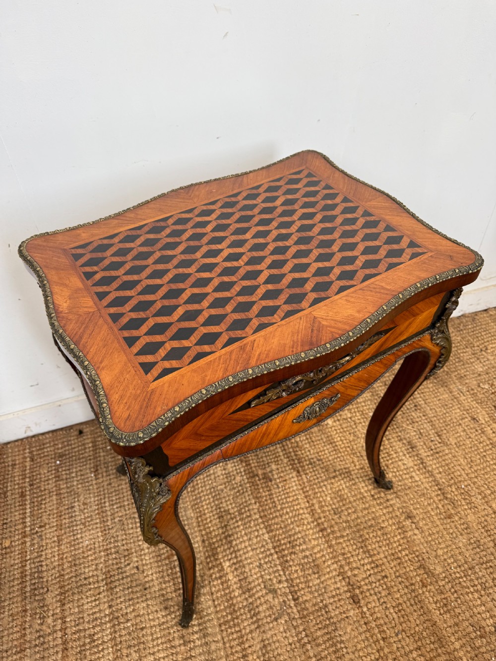 A 19th-century French Napoleon III work table with diamond geometric parquetry, gilt bronze mounts, and cabriole legs. View II