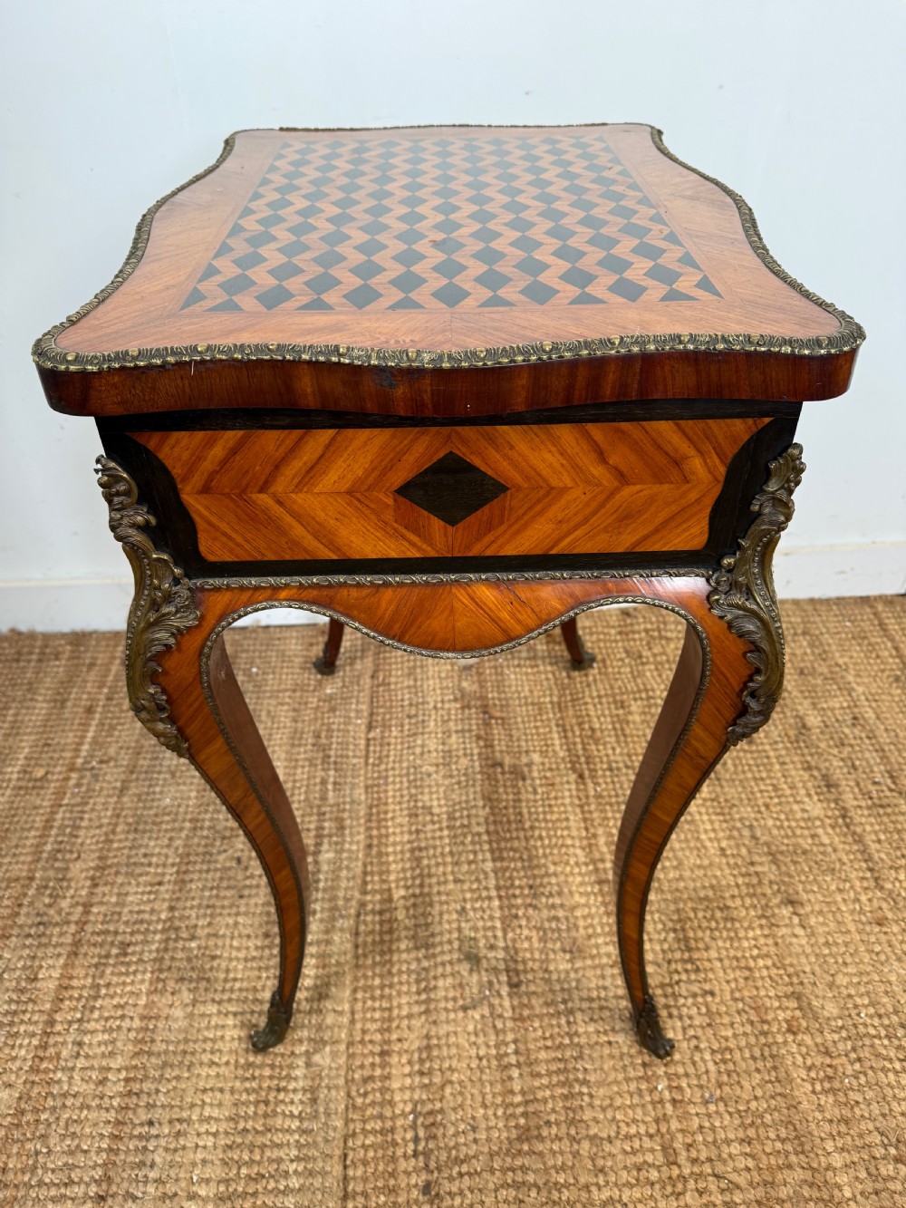 A 19th-century French Napoleon III work table with diamond geometric parquetry, gilt bronze mounts, and cabriole legs. View VIII
