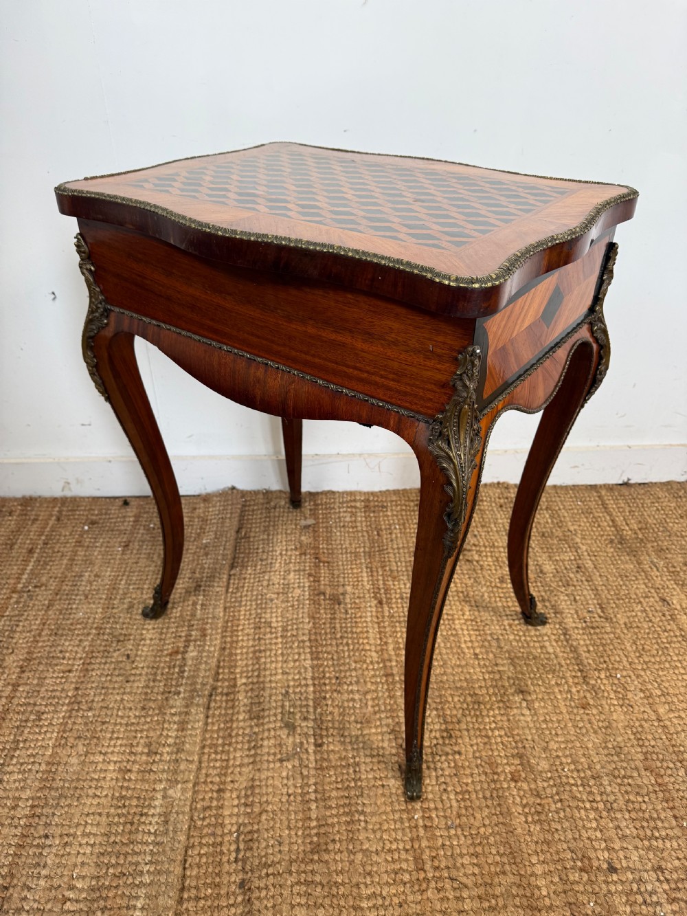 A 19th-century French Napoleon III work table with diamond geometric parquetry, gilt bronze mounts, and cabriole legs. View IX