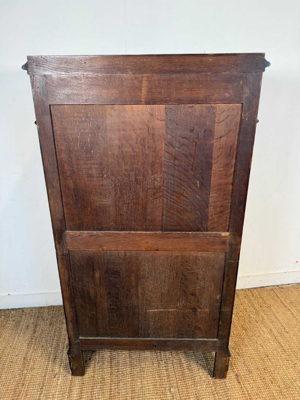 A tall, narrow flame mahogany semainier chest featuring seven drawers with turned knobs and central keyholes set on a moulded plinth base. View XIII