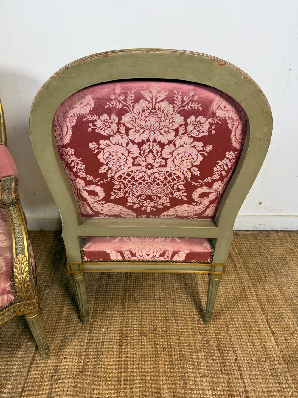 A pair of Louis XVI style French open armchairs featuring carved giltwood frames, fluted legs, and pink damask pattern upholstery. View III