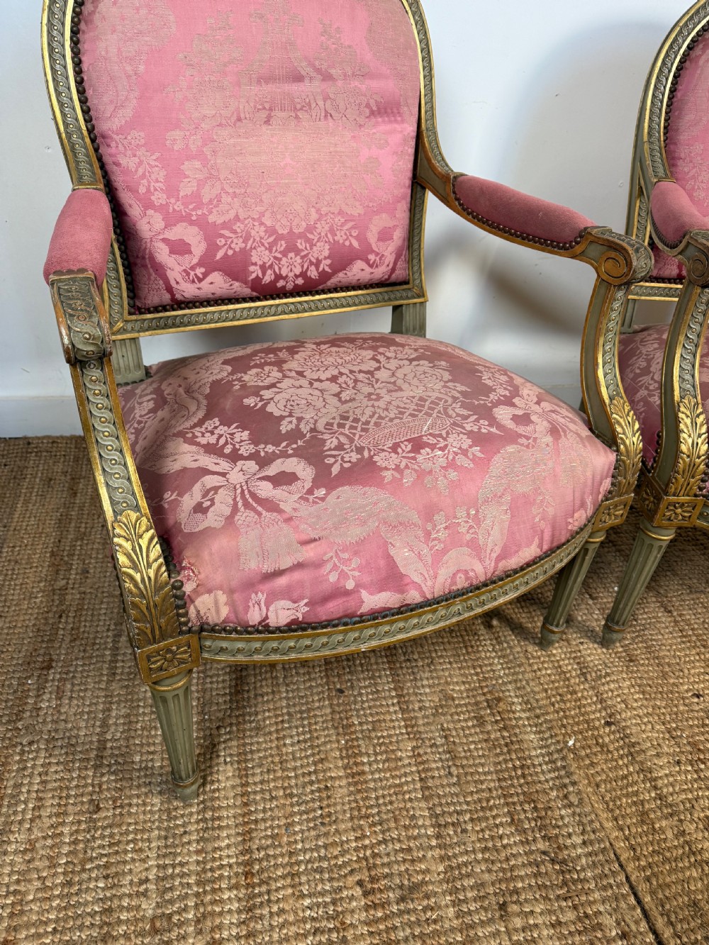A pair of Louis XVI style French open armchairs featuring carved giltwood frames, fluted legs, and pink damask pattern upholstery. View VIII