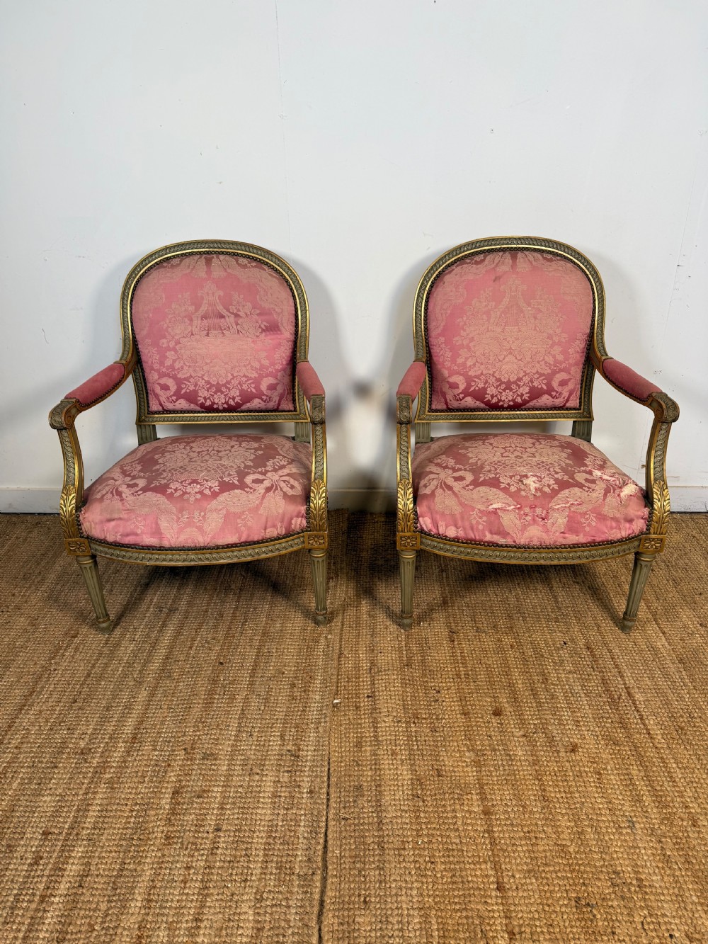 A pair of Louis XVI style French open armchairs featuring carved giltwood frames, fluted legs, and pink damask pattern upholstery. View XI