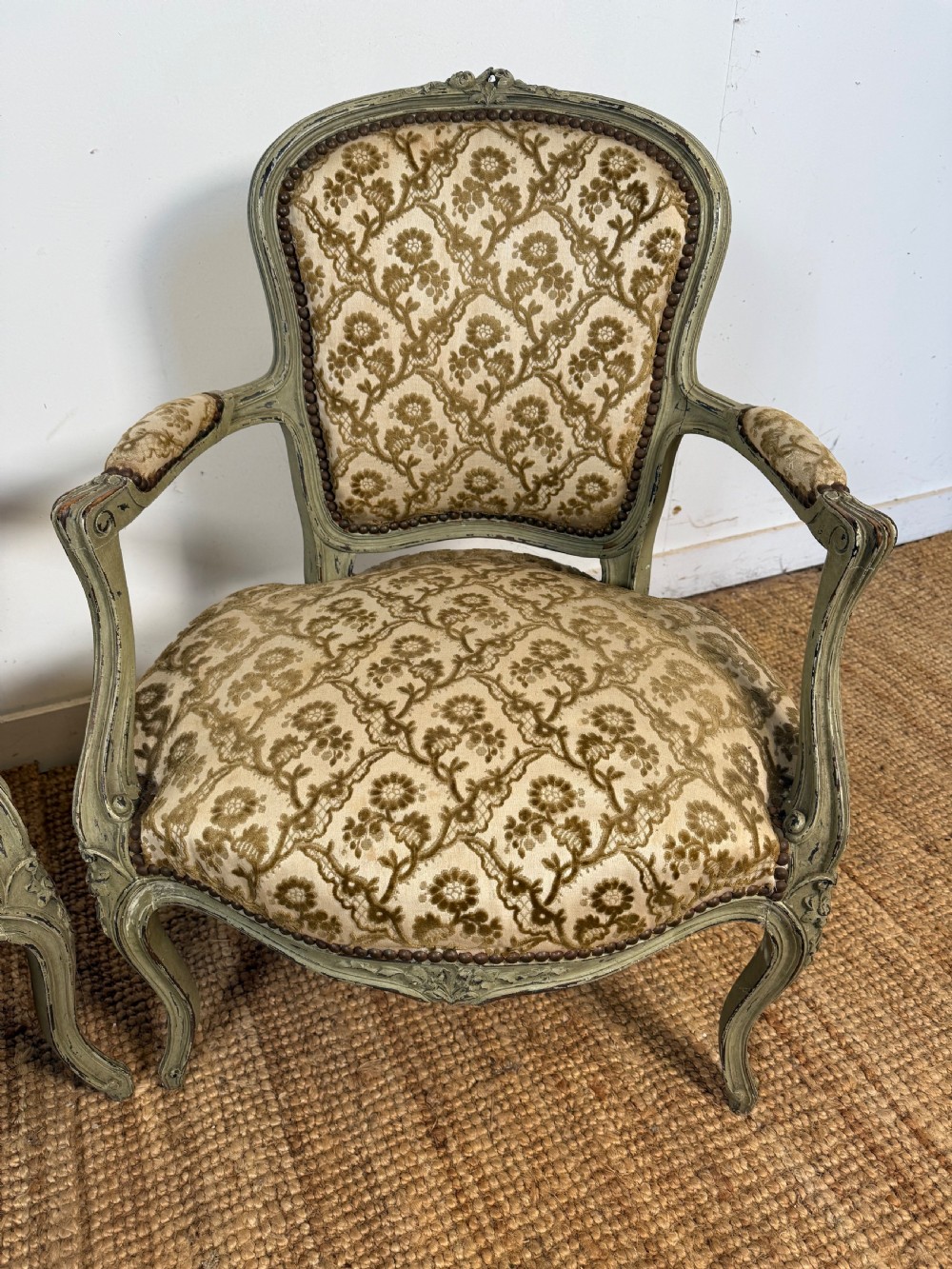 A pair of late 19th-century French style open armchairs with carved muted green painted frames and patterned velvet fabric. View III
