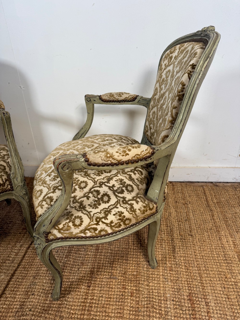 A pair of late 19th-century French style open armchairs with carved muted green painted frames and patterned velvet fabric. View VI