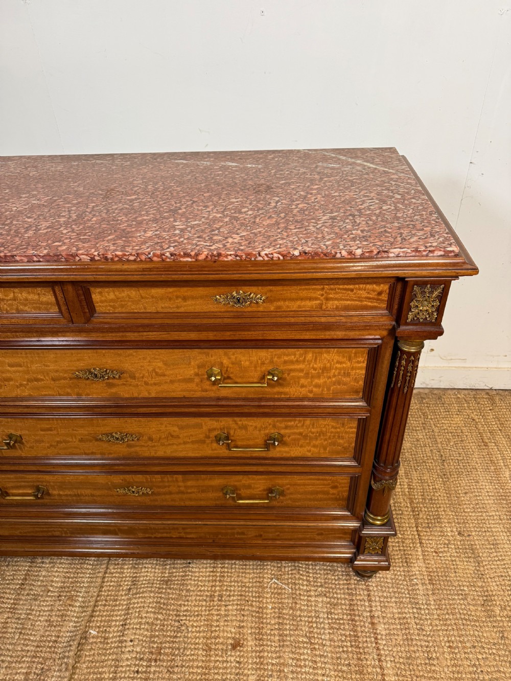 A 19th-century French mahogany commode featuring a red marble top, brass drop handles, and fluted corner columns. View II