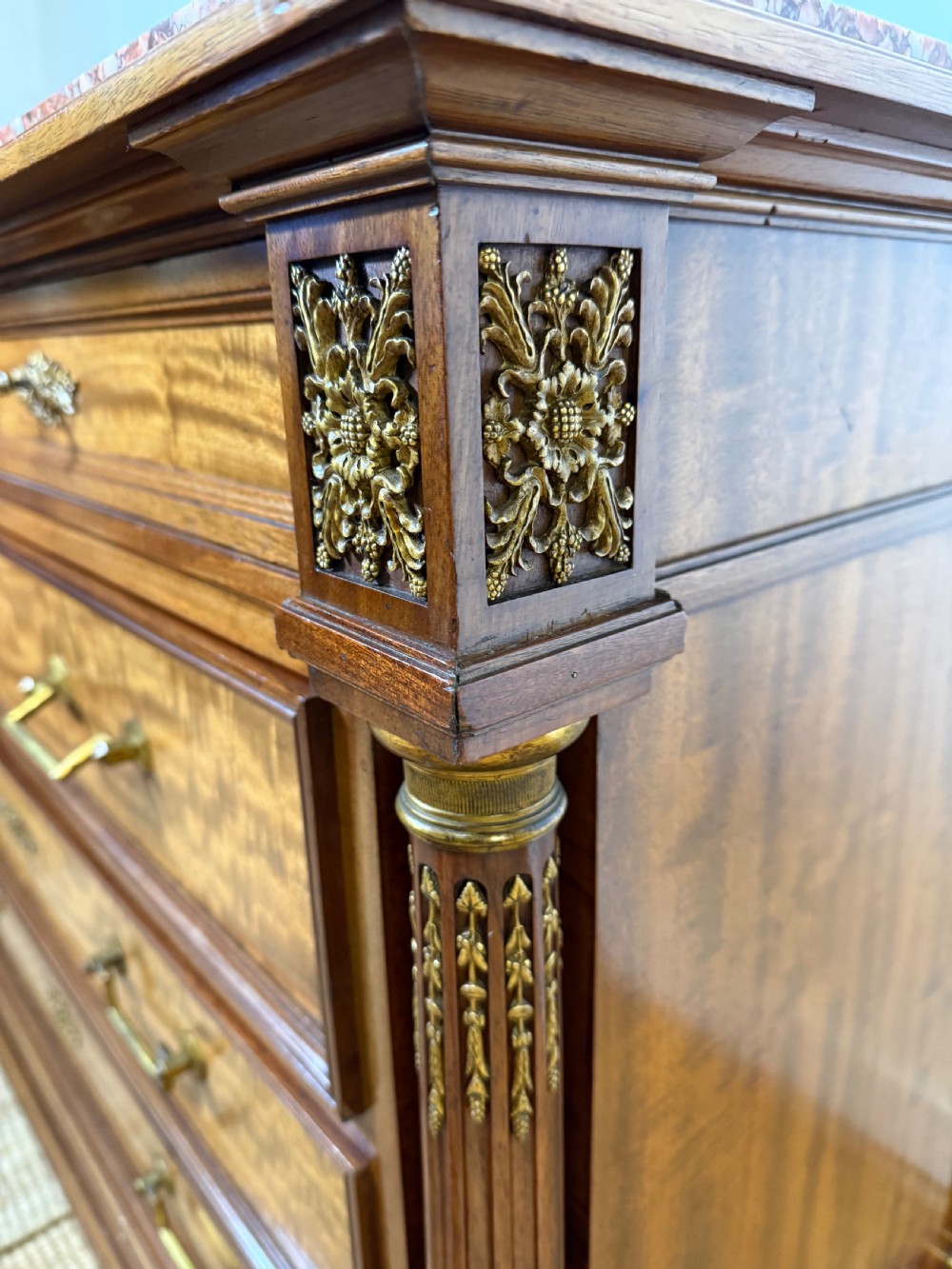 A 19th-century French mahogany commode featuring a red marble top, brass drop handles, and fluted corner columns. View VIII