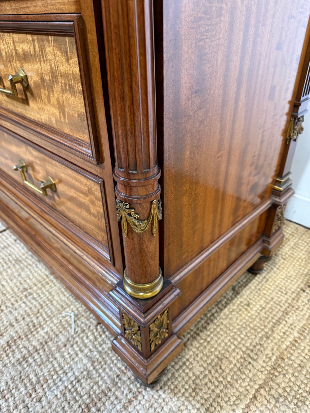 A 19th-century French mahogany commode featuring a red marble top, brass drop handles, and fluted corner columns. View IX