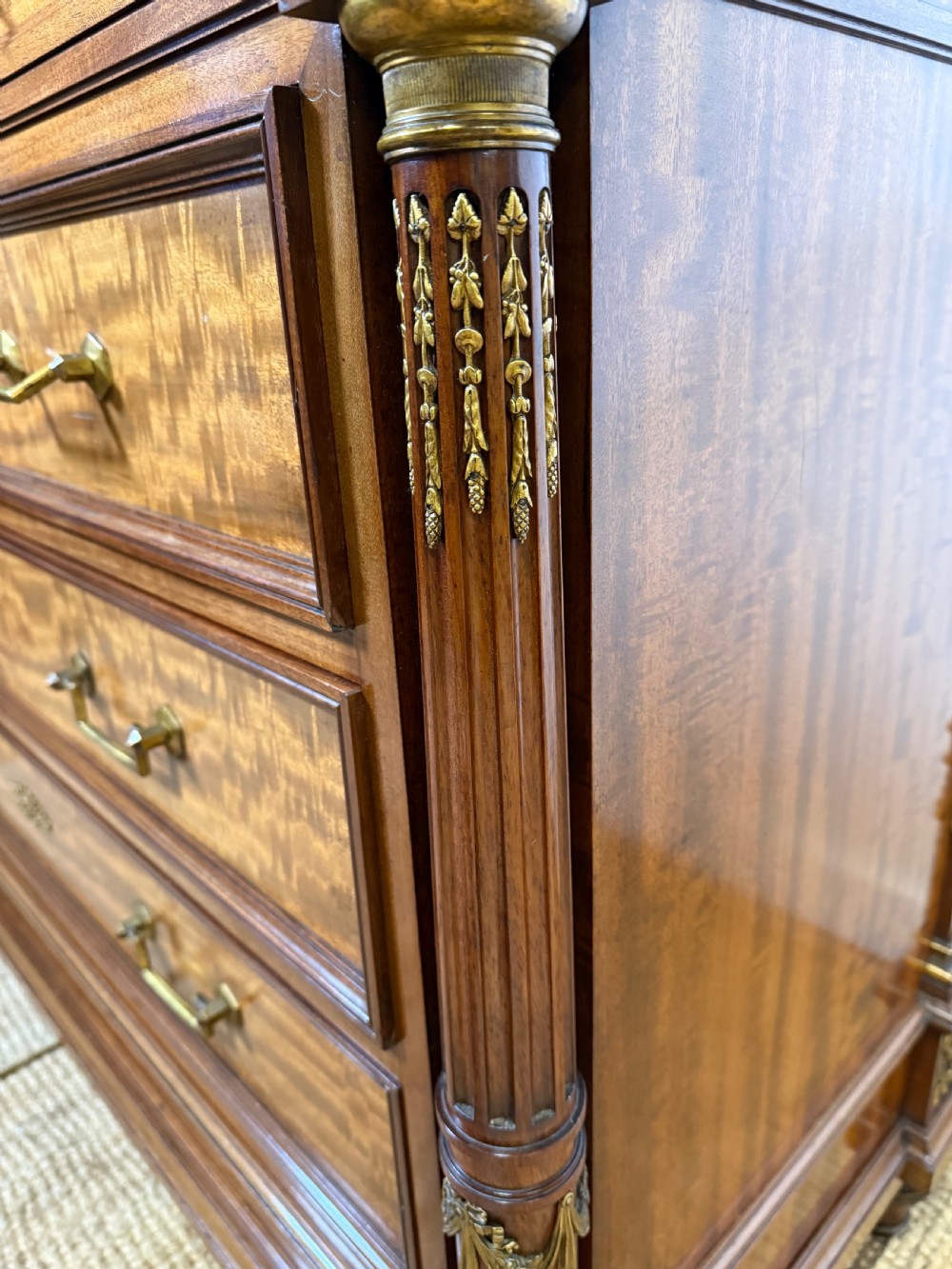 A 19th-century French mahogany commode featuring a red marble top, brass drop handles, and fluted corner columns. View X