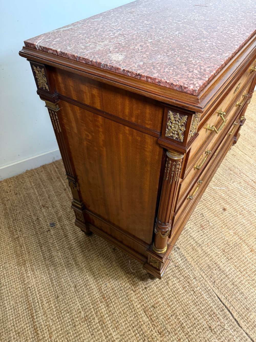 A 19th-century French mahogany commode featuring a red marble top, brass drop handles, and fluted corner columns. View XI