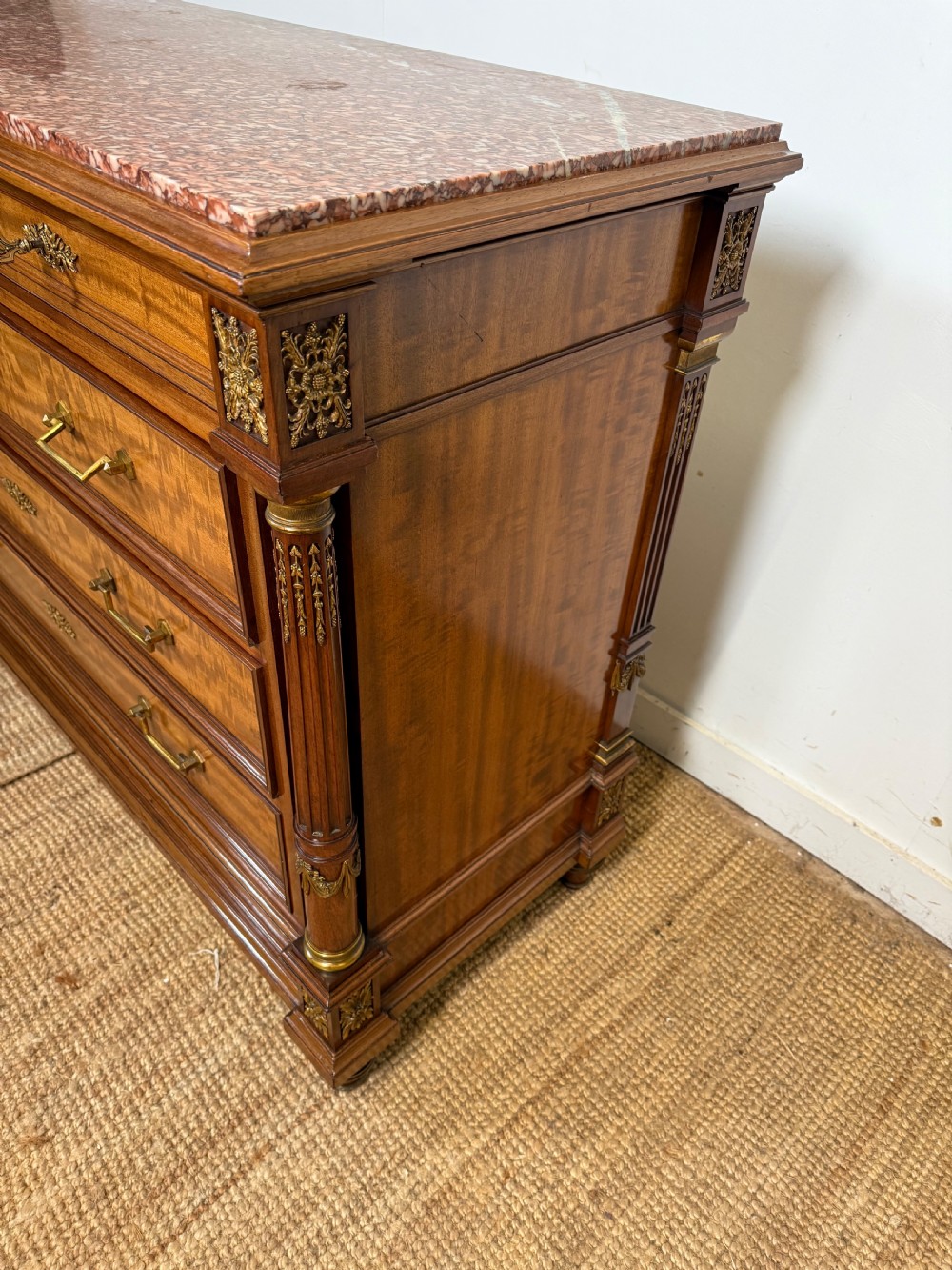 A 19th-century French mahogany commode featuring a red marble top, brass drop handles, and fluted corner columns. View XIII