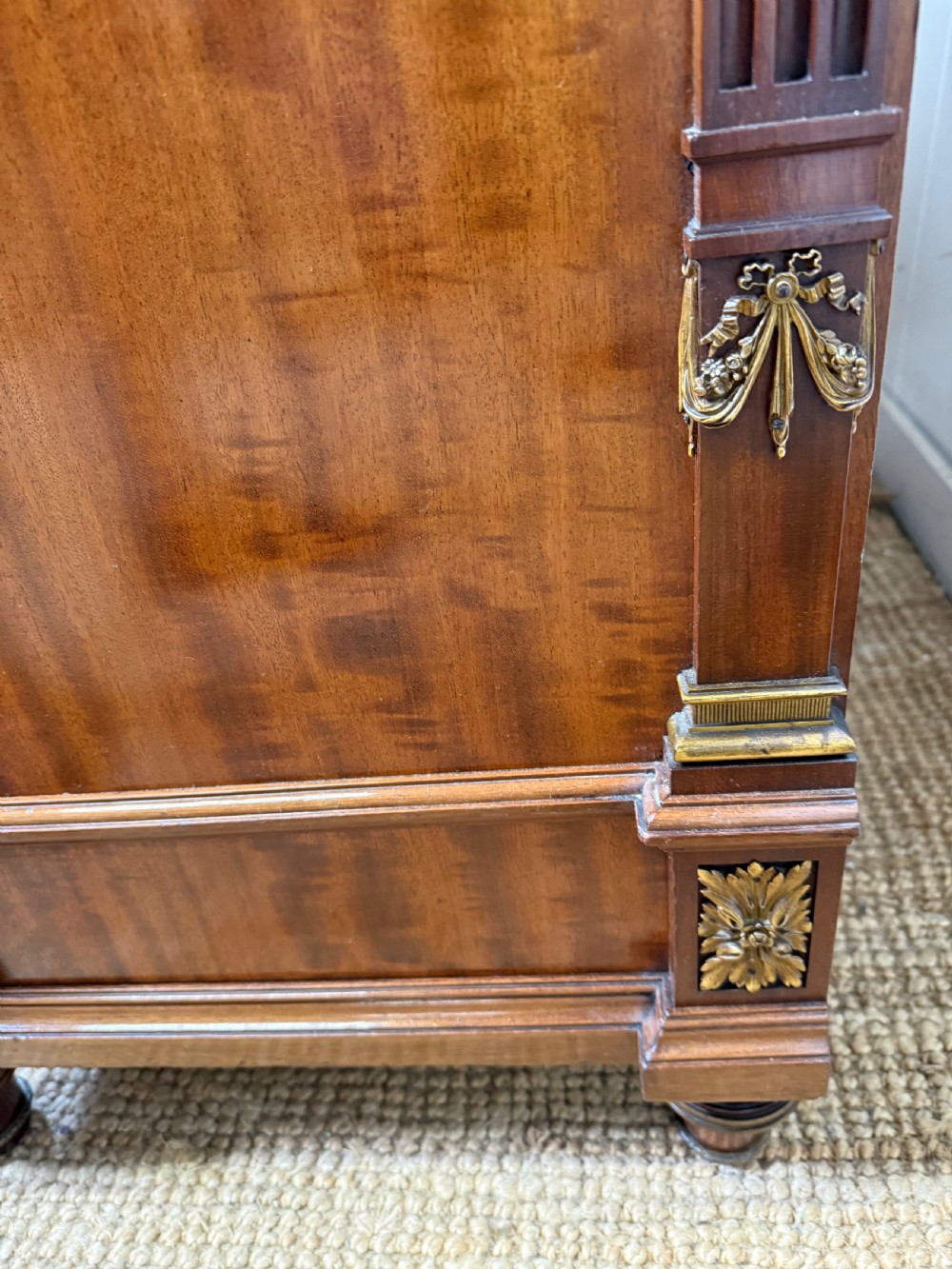 A 19th-century French mahogany commode featuring a red marble top, brass drop handles, and fluted corner columns. View XV