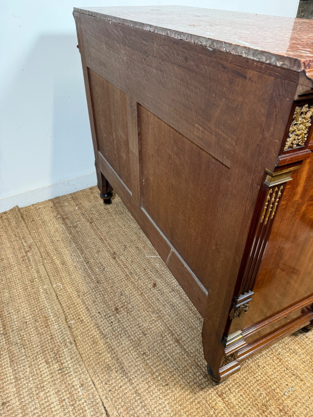 A 19th-century French mahogany commode featuring a red marble top, brass drop handles, and fluted corner columns. View XVII
