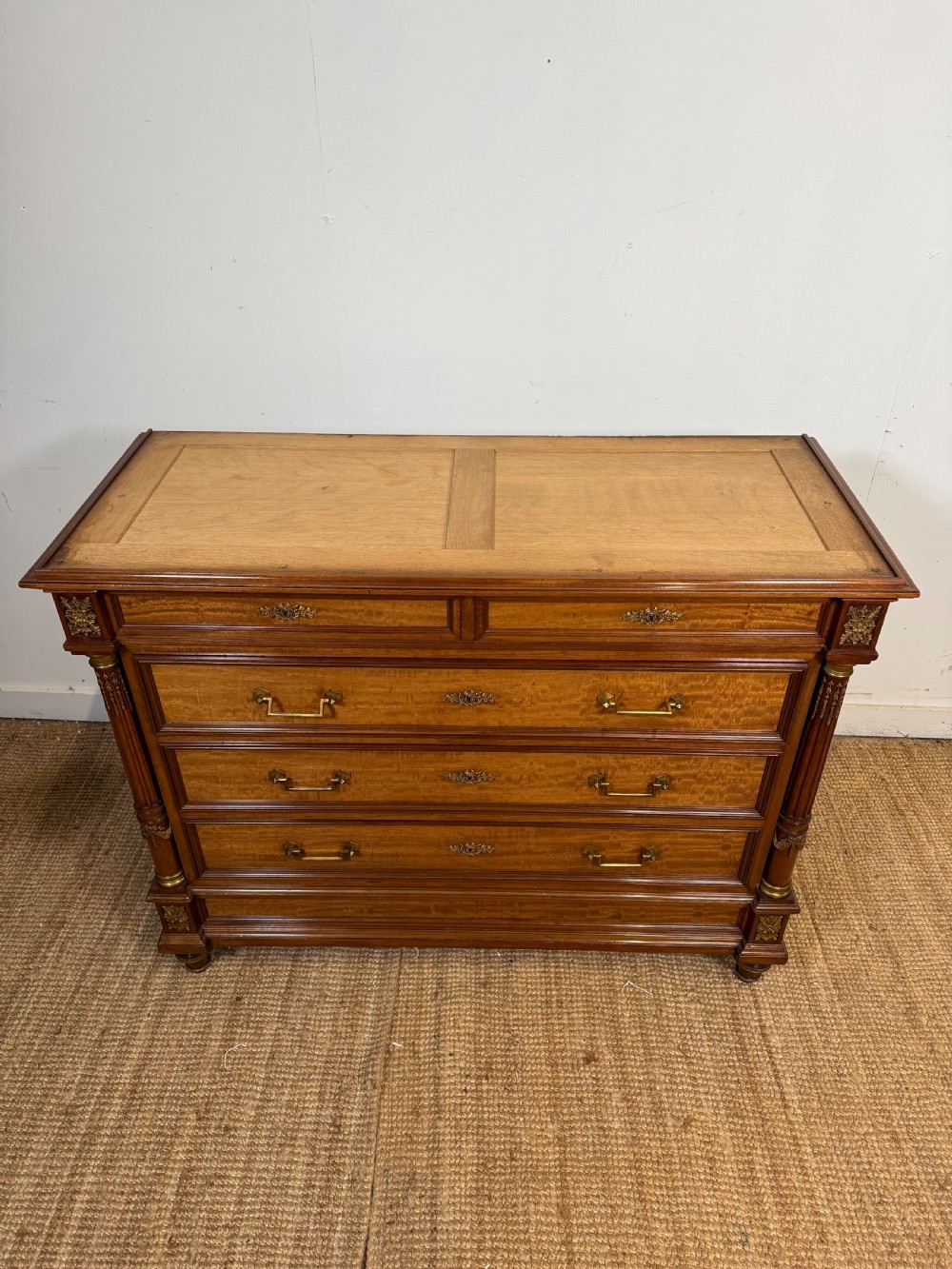 A 19th-century French mahogany commode featuring a red marble top, brass drop handles, and fluted corner columns. View XX