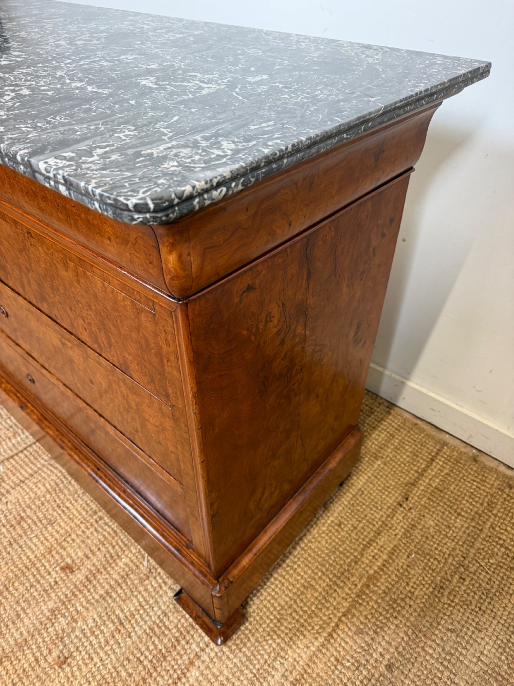 A rectangular 19th-century burr elm commode featuring a grey mottled marble top and three long drawers with central key escutcheons. View XI