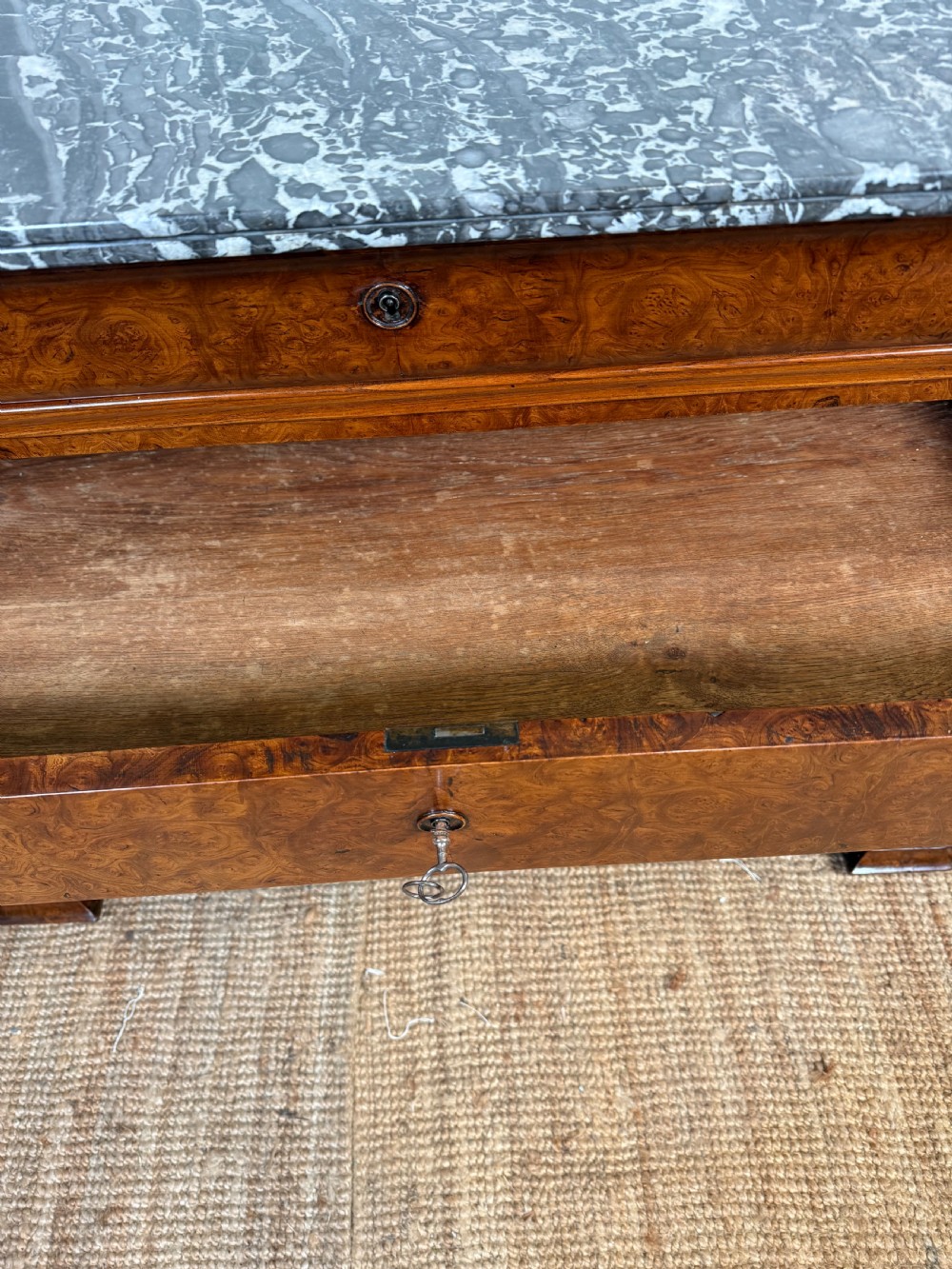 A rectangular 19th-century burr elm commode featuring a grey mottled marble top and three long drawers with central key escutcheons. View XIII