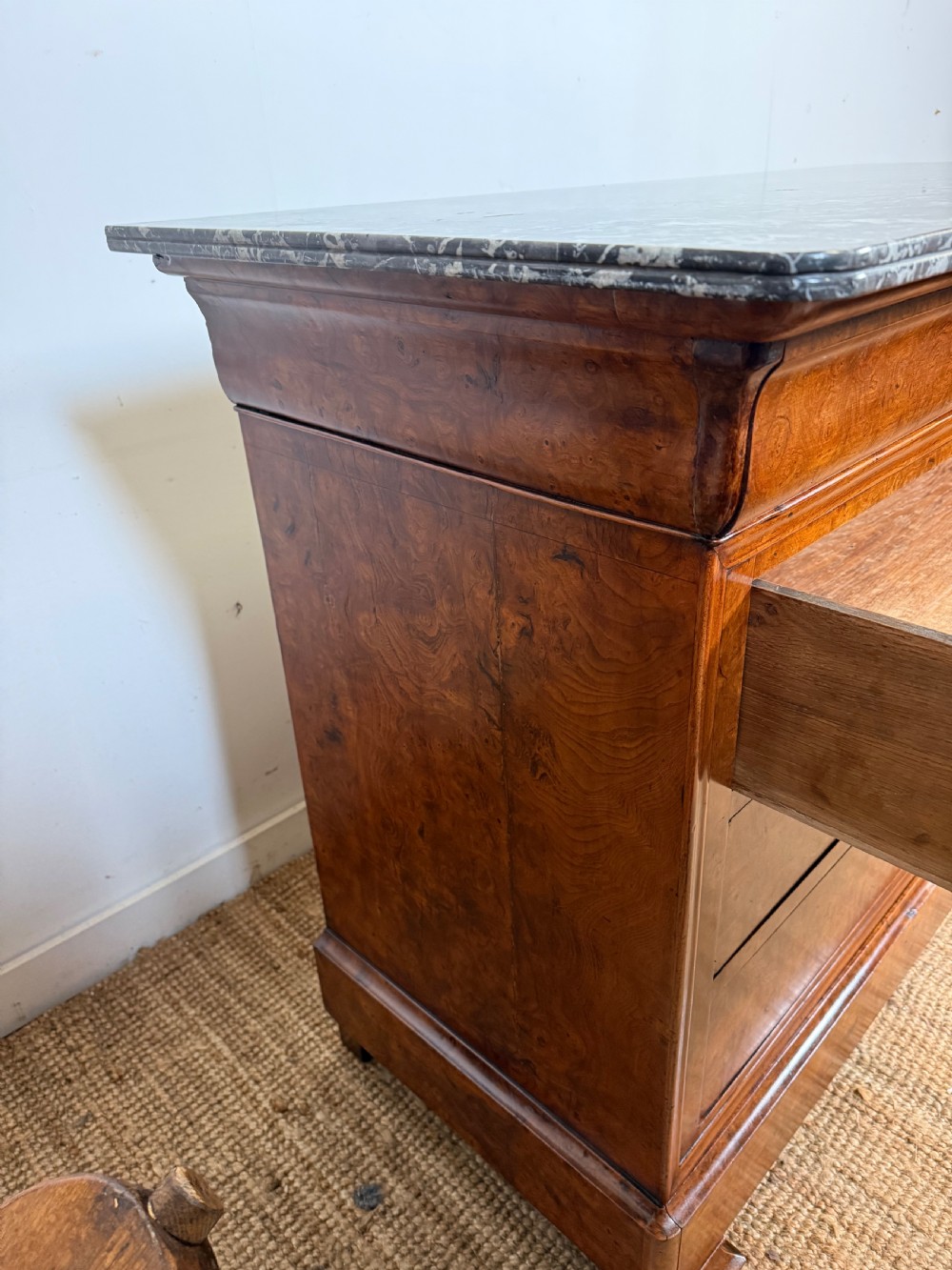 A rectangular 19th-century burr elm commode featuring a grey mottled marble top and three long drawers with central key escutcheons. View XV